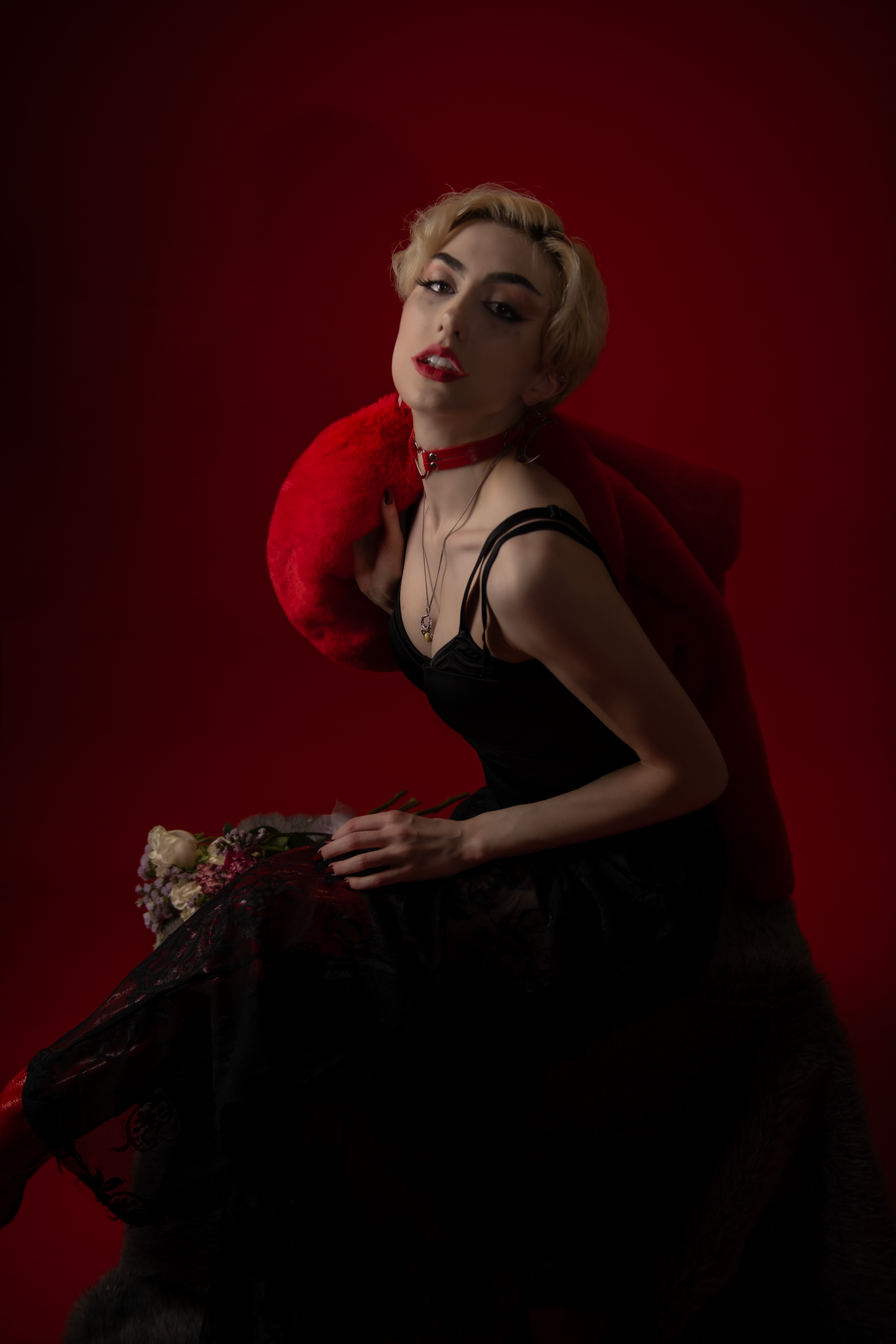 Dramatic noir-style portrait series with figure in black dress against deep red background posing in vintage glamour style.