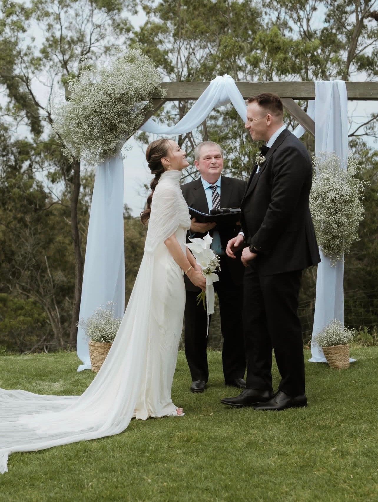 Bride and groom at farm viago bride with a twisted braid leading into a bubble ponytail