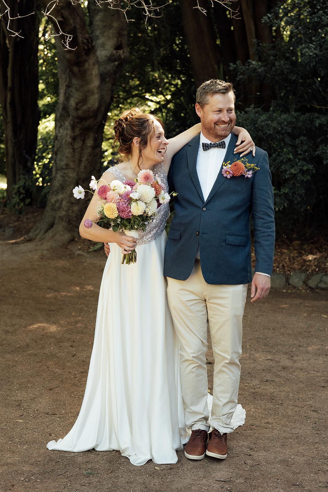 Forrest wedding with a bridal hairstyle that is a messy textured whimsical high bun that is soft and loose