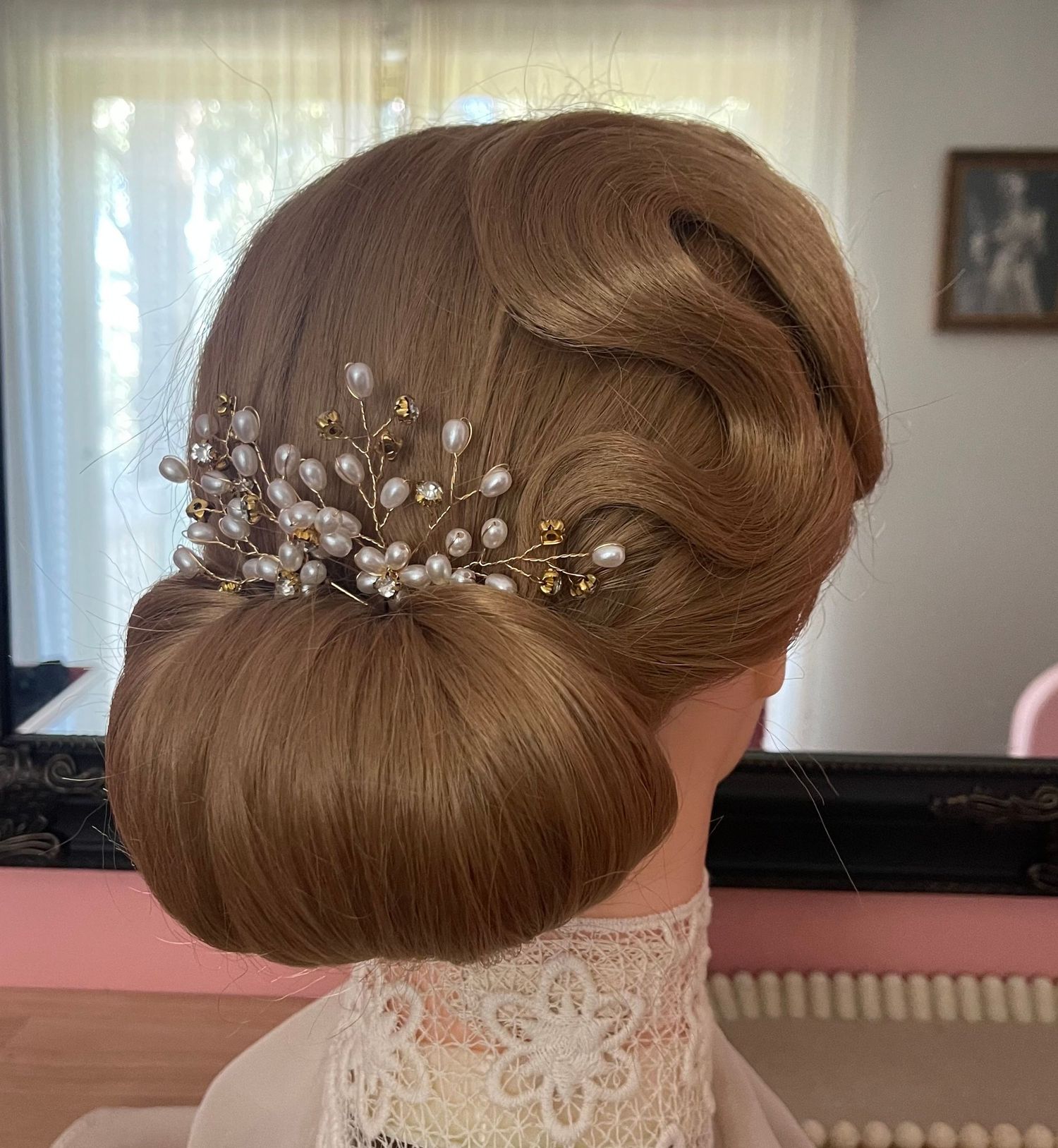 Vintage styled bridal hair s-curl through front for detail going into a low chignon very neat and high shine styled with diamond accessory