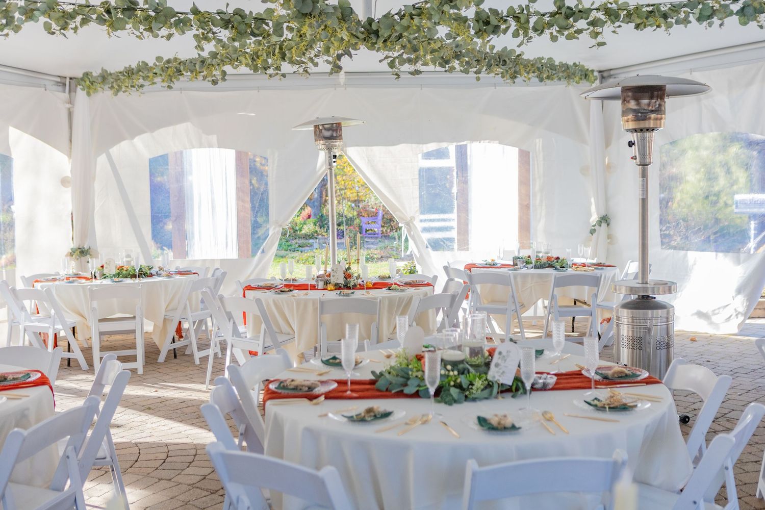 all white tent setup for cocktail hour during a wedding in avon indiana at the avon gardens