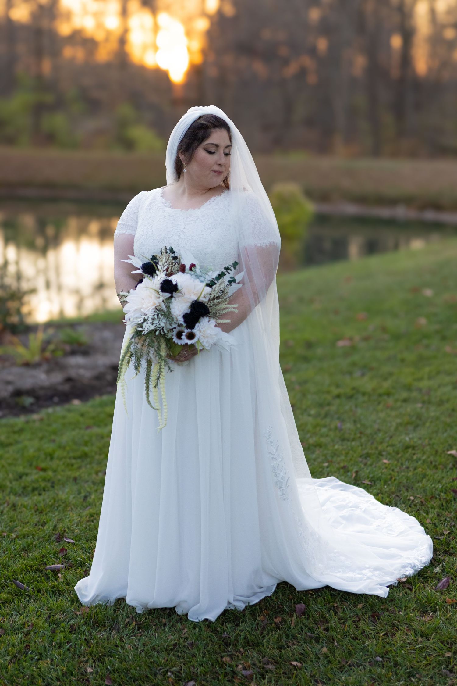 a bride wearing a white dress during her wedding in avon indiana at the avon gardens