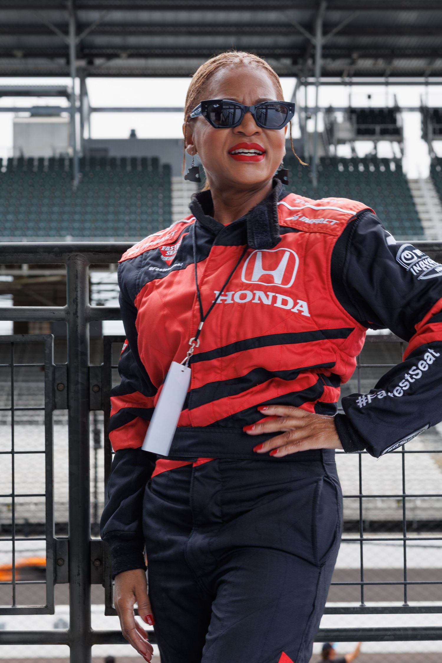 lady standing by the railing at the indy 500 motorsport in speedway indiana.