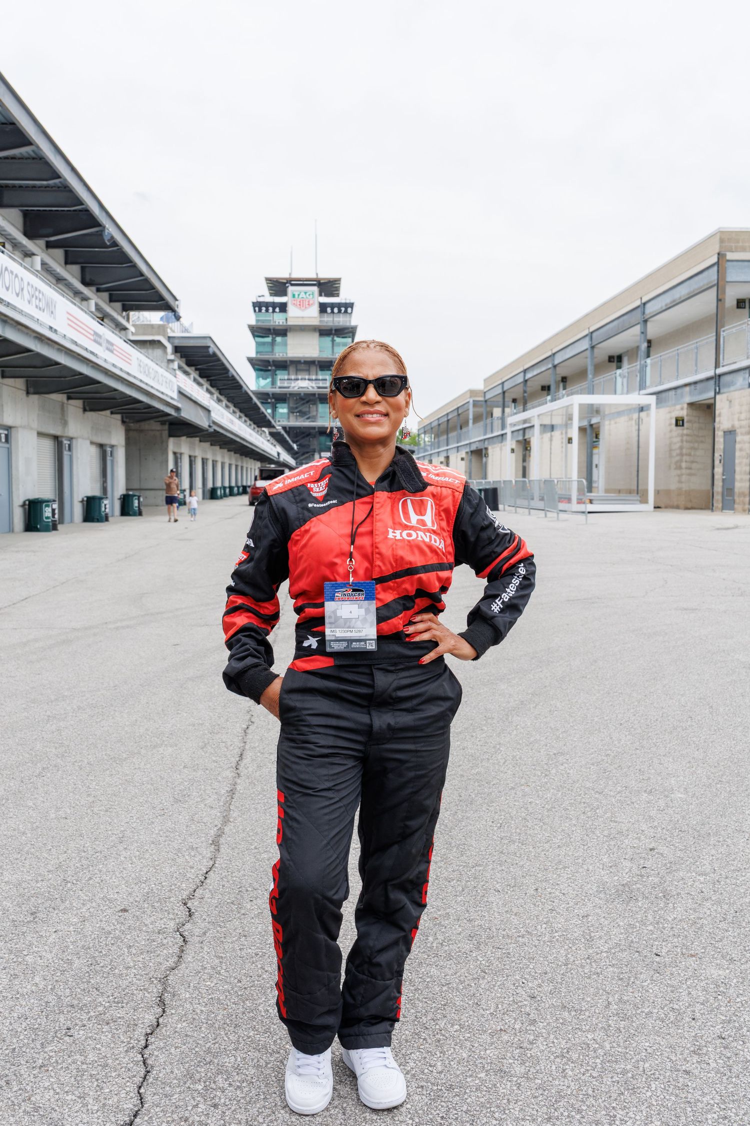 lady posing next to a the famous IMS Pagoda building in Indianapolis.