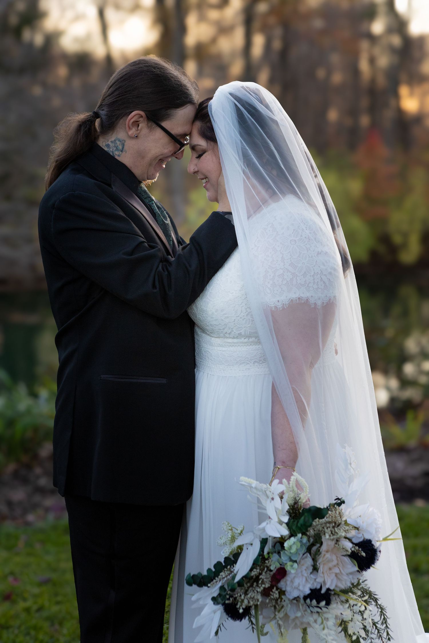 beautiful couple holding each other during a wedding in avon indiana at the avon gardens
