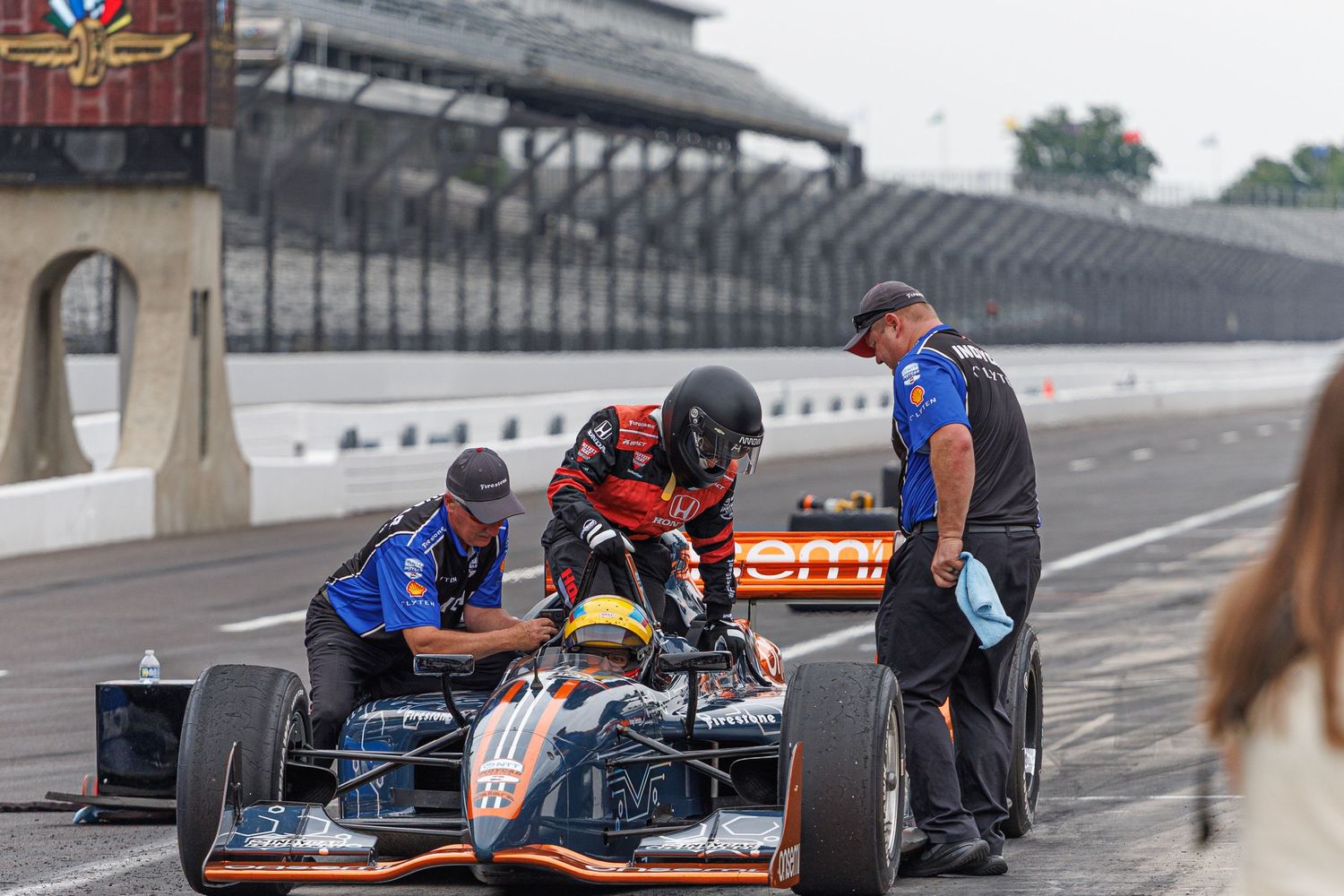 racer exiting a racecar from the indianapolis indy 500.
