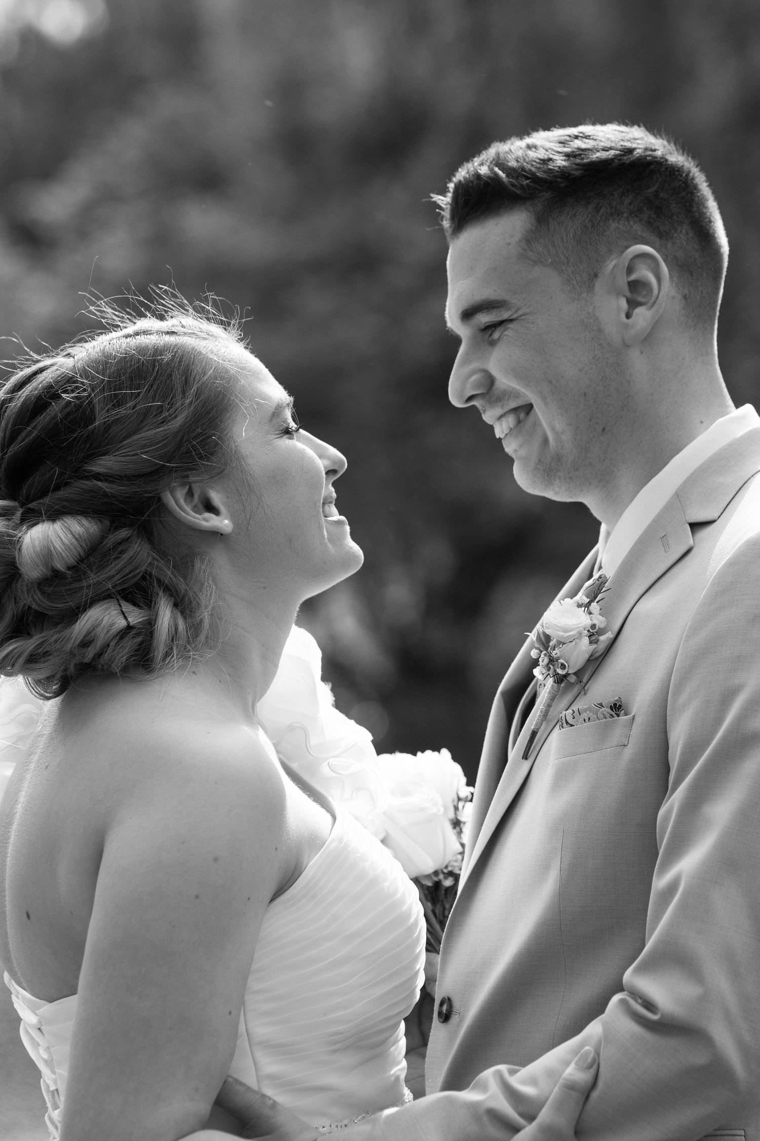 Black and white portrait of a couple sharing a tender moment on their wedding day.