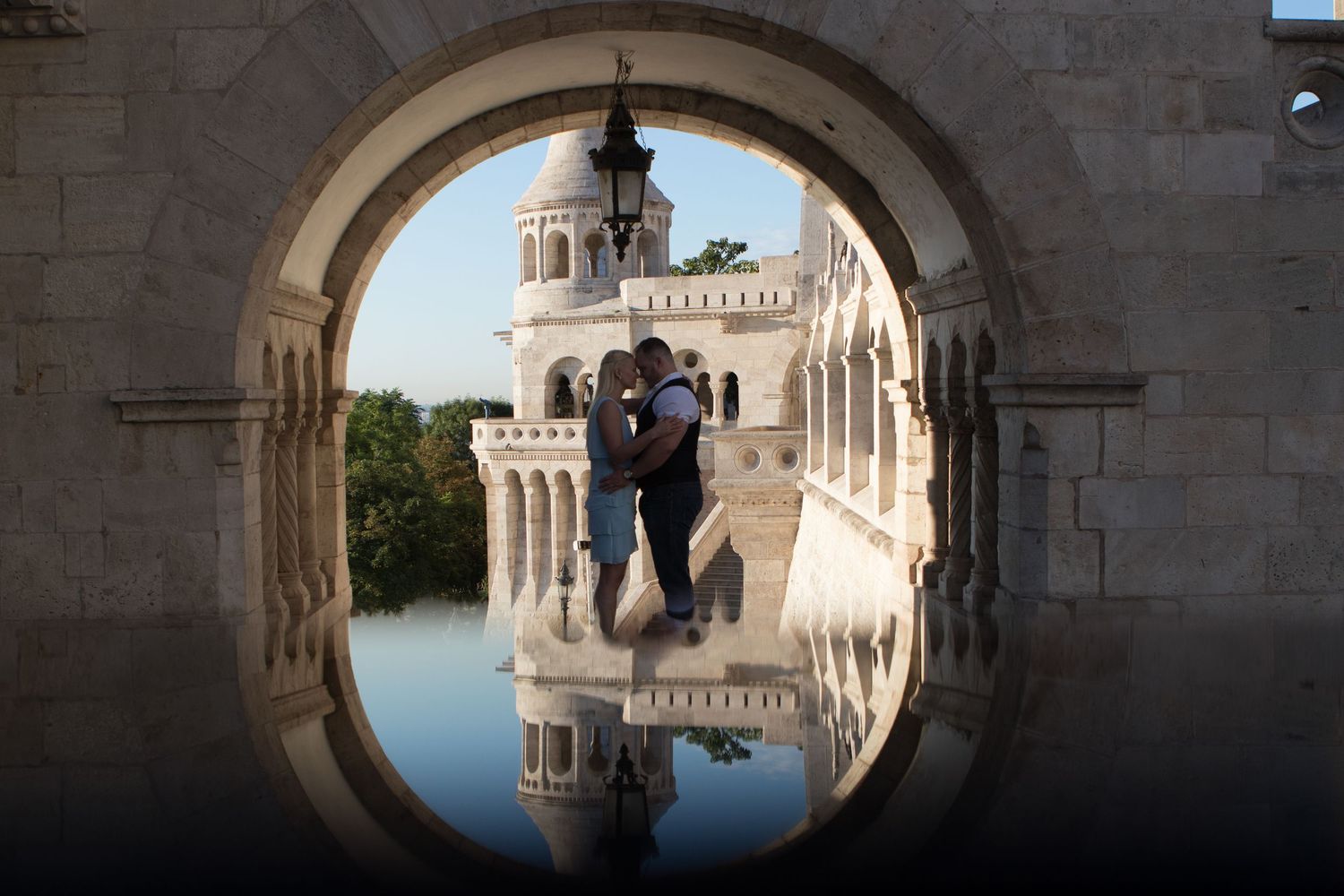Stone archway frames architectural views of historic buildings and domes.