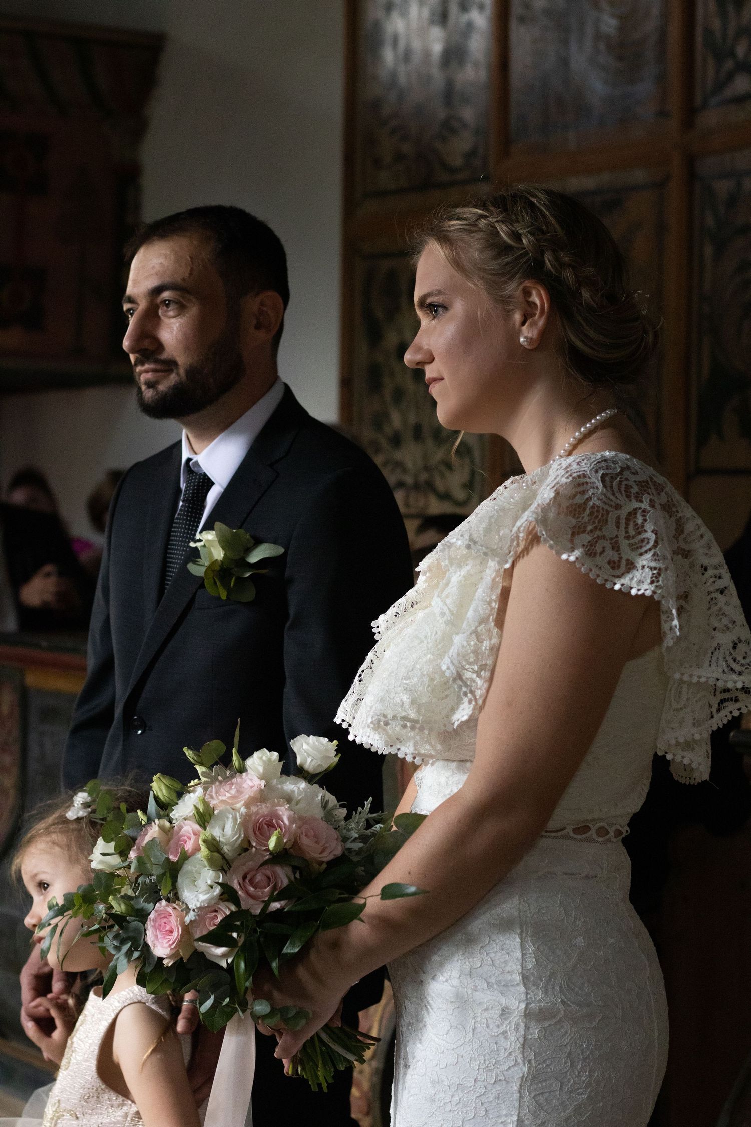 Intimate wedding ceremony moment captured in historic church interior.