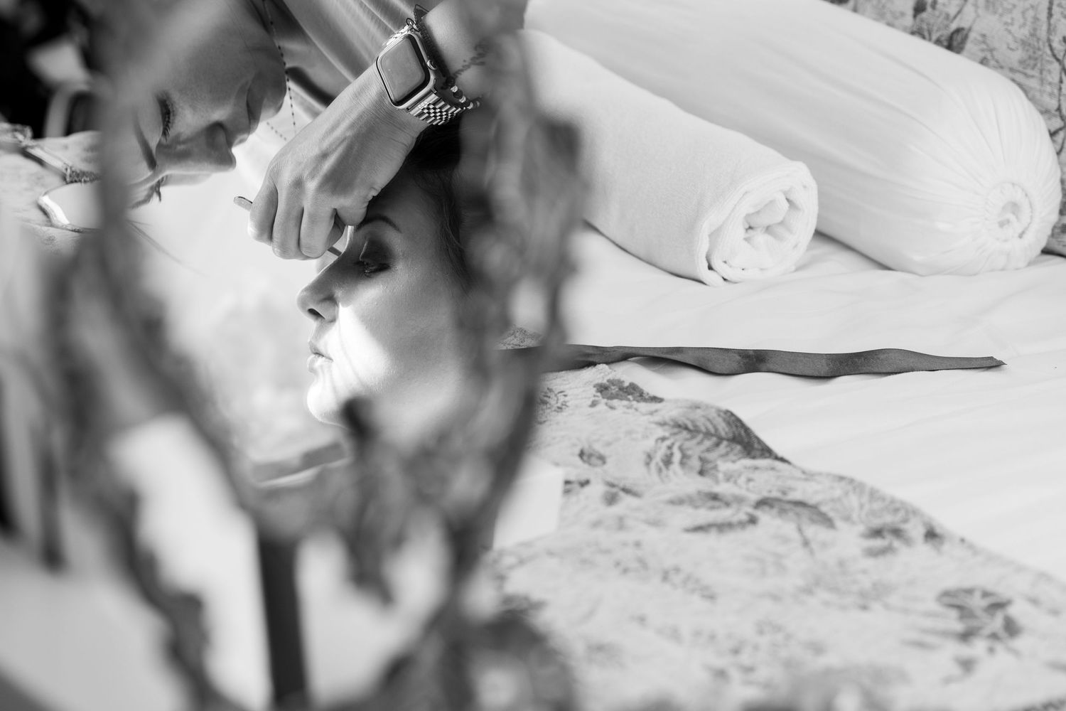 Artistic black and white close-up shot of wedding day preparations.