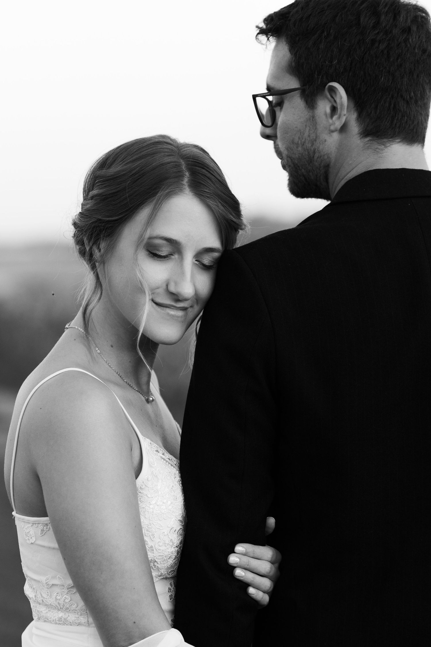 Black and white intimate portraits of a couple in formal wedding attire.