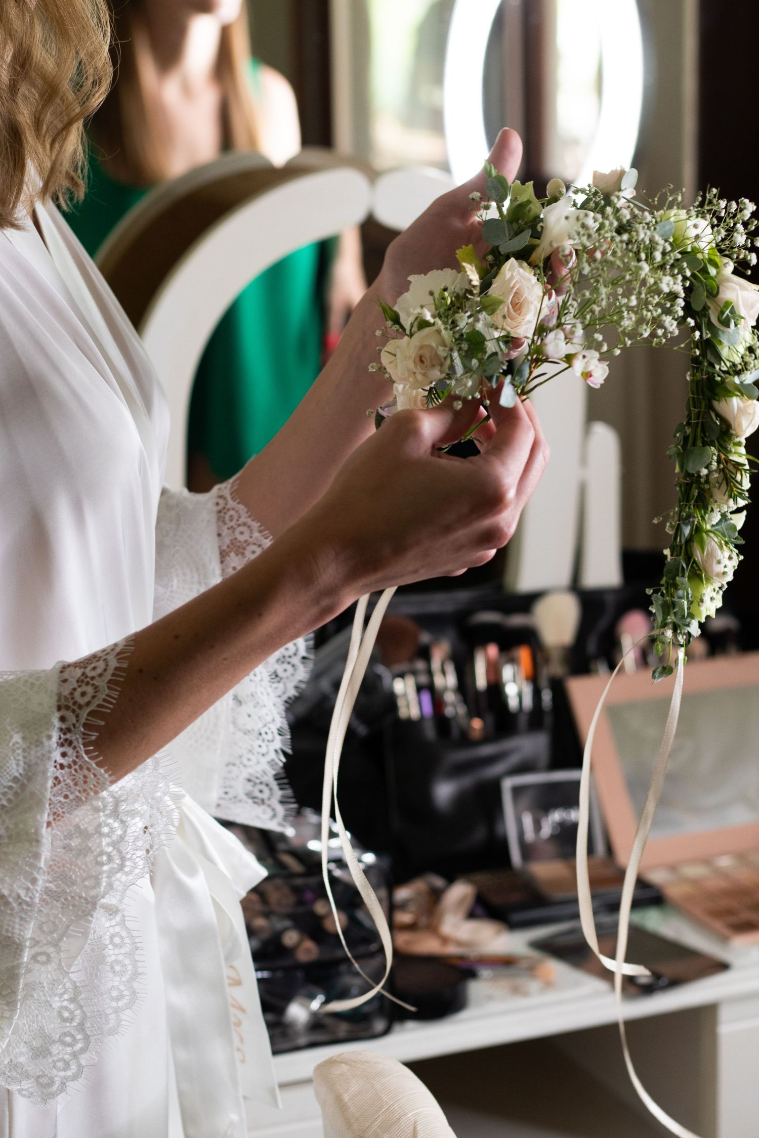 Wedding dress details showing delicate lace trim and floral bouquet preparations.