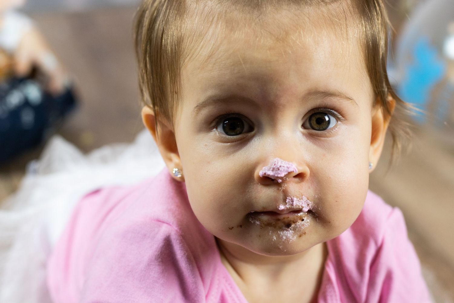 Series showing messy cake-covered faces during first birthday celebration.