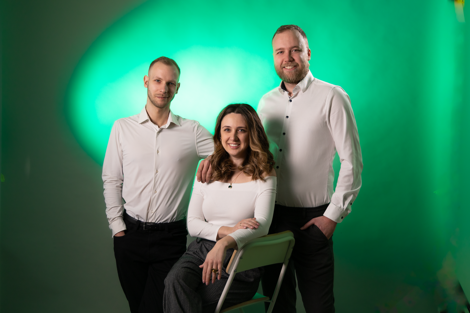 Professional studio photo with green backdrop lighting.