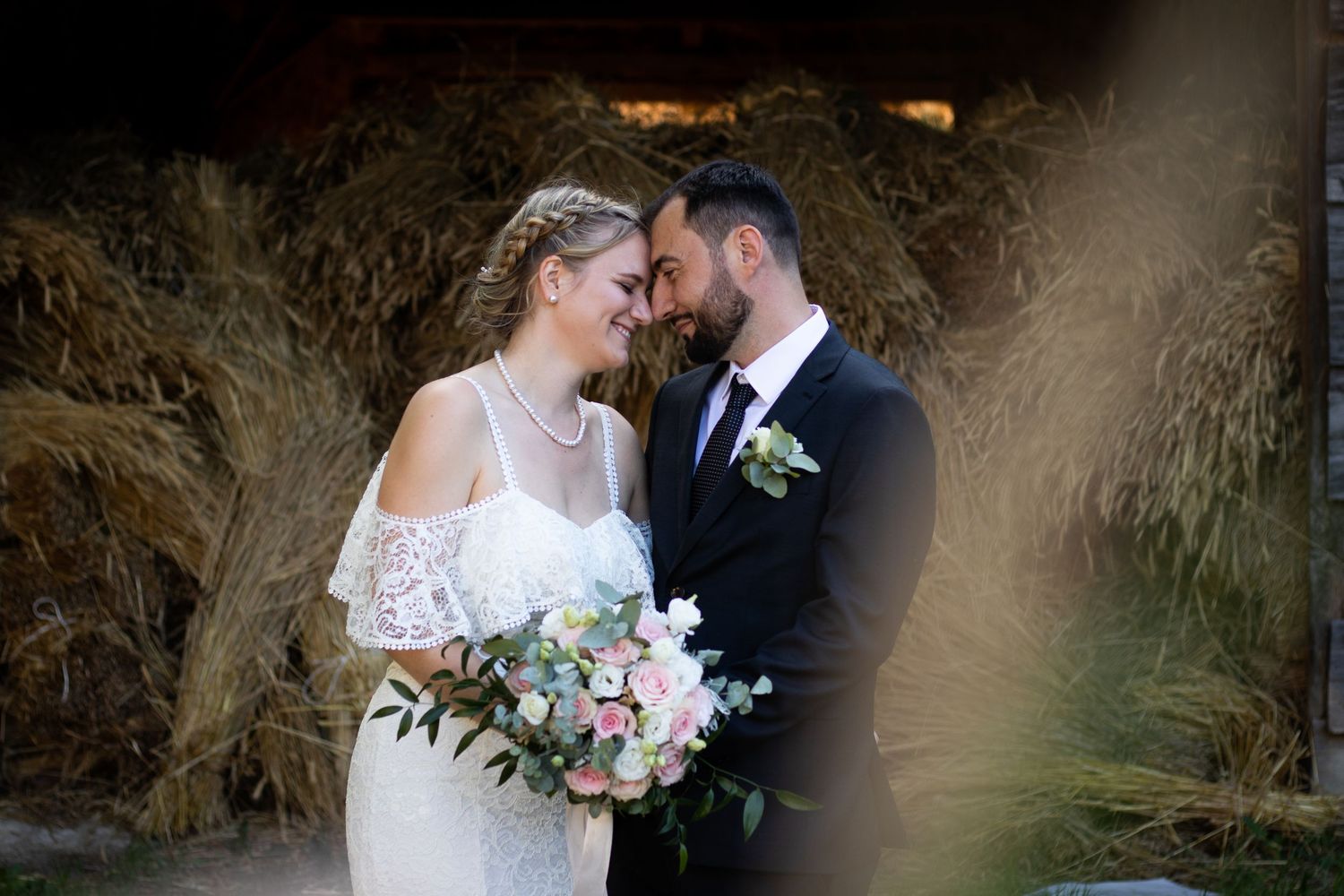 An intimate wedding moment captured against a natural backdrop with soft lighting and elegant florals.