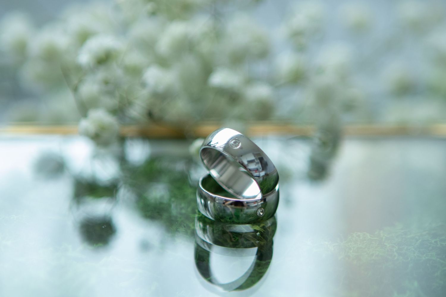 Close-up macro shots of wedding rings with soft bokeh background.