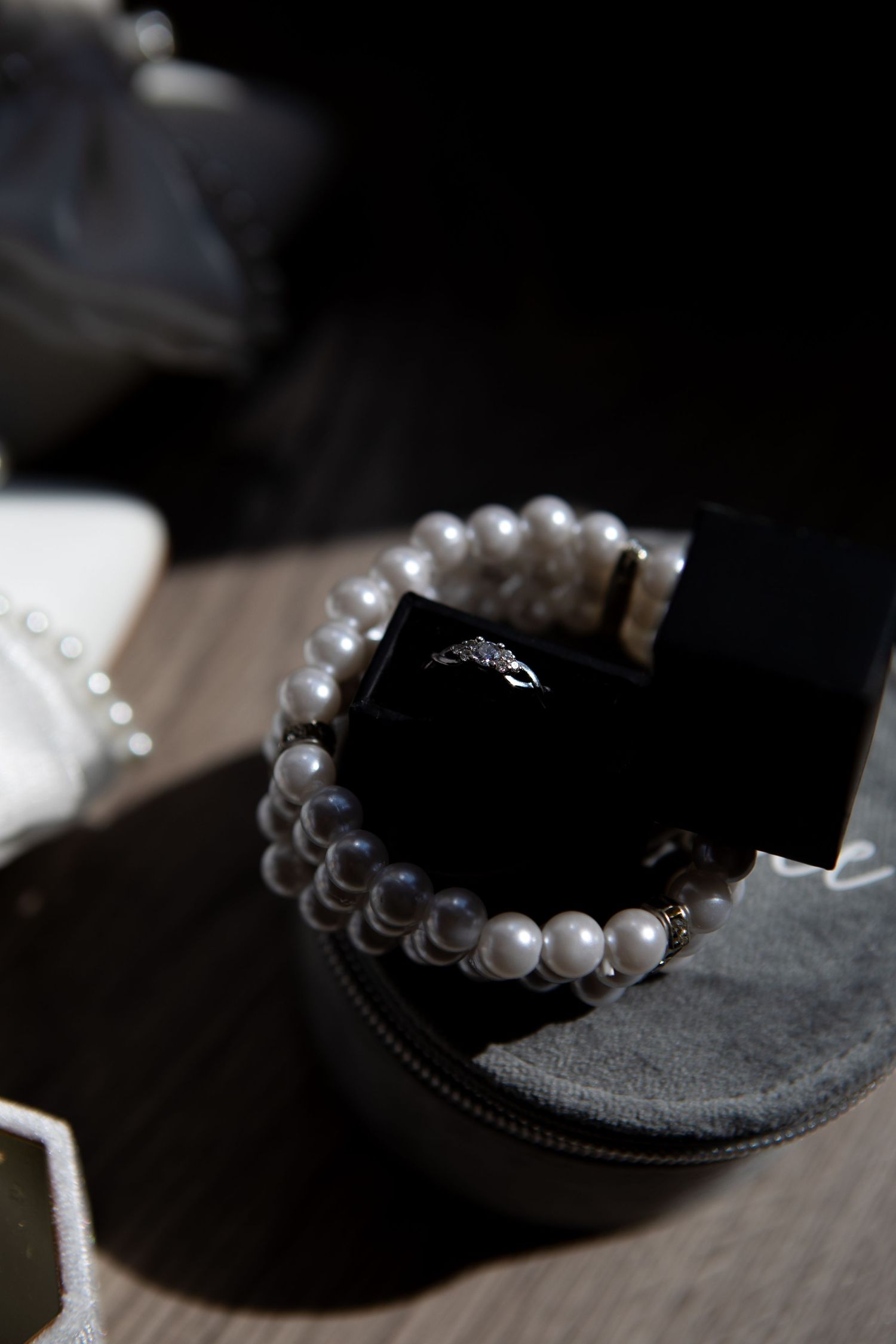 Pearl bracelet displayed on dark velvet jewelry box.