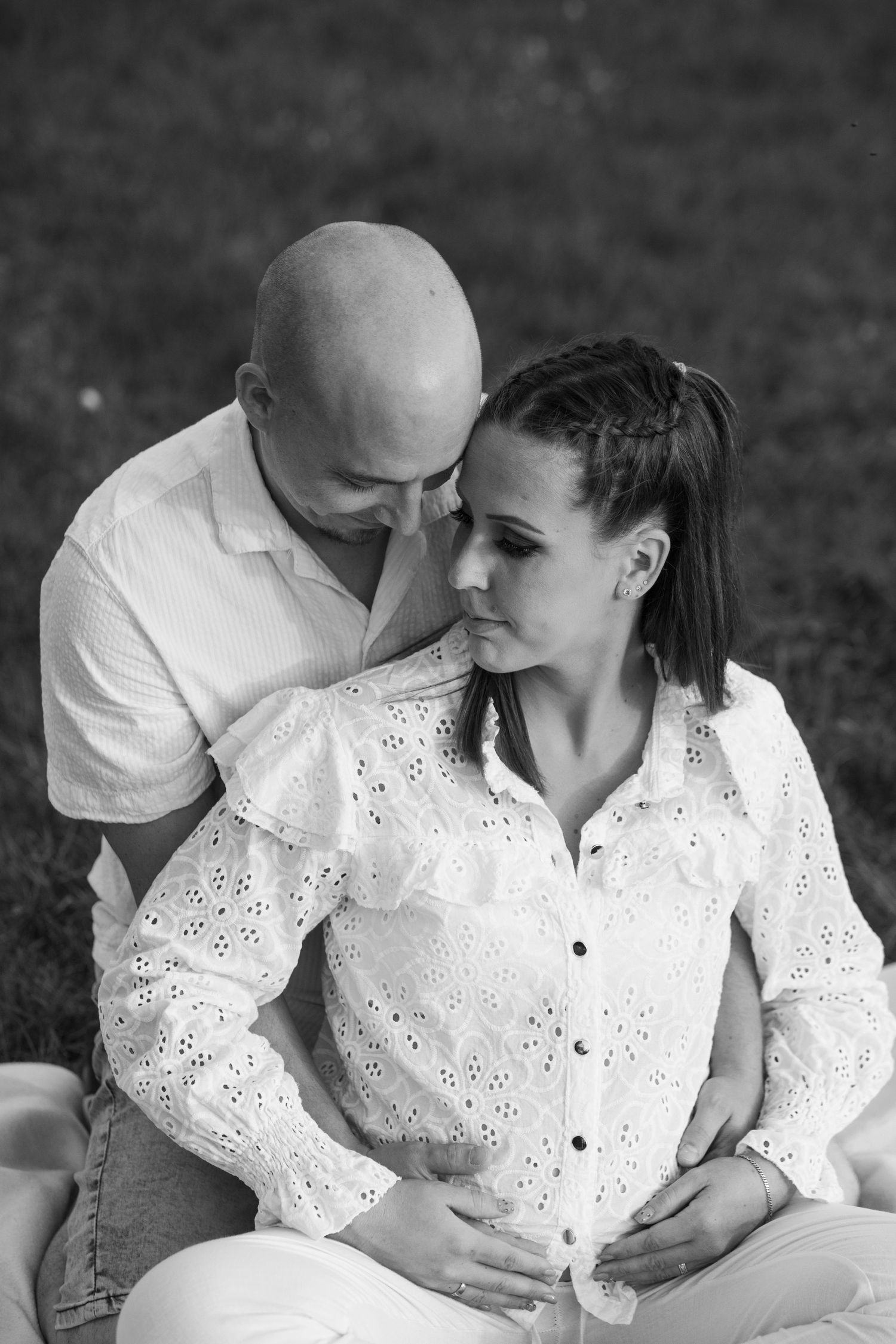 An intimate black and white portrait series of a couple in white clothing.