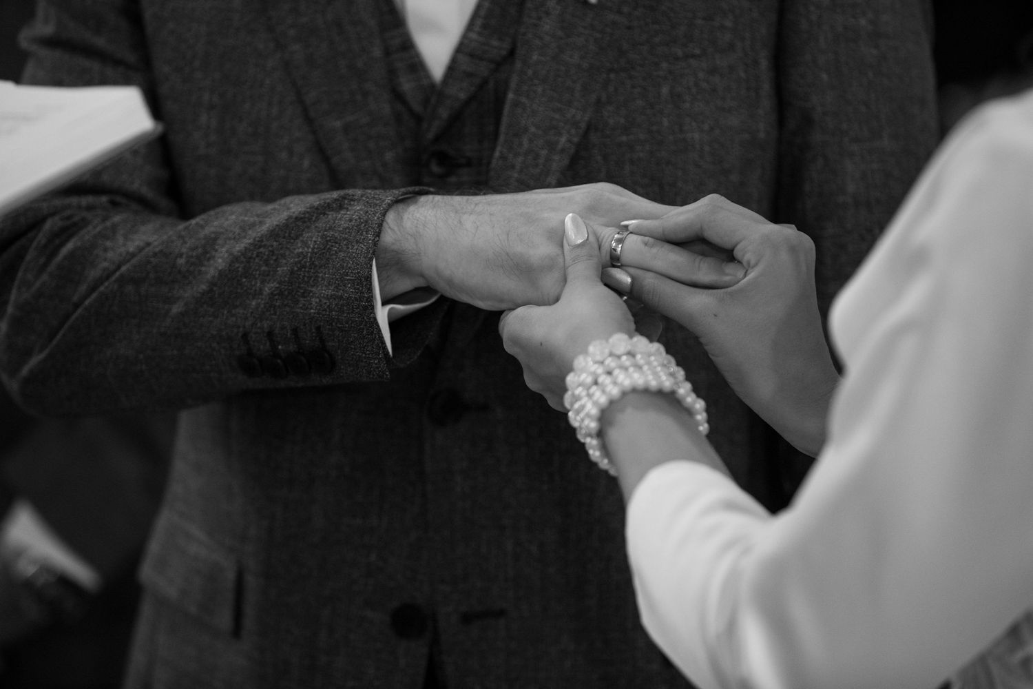 Couple sharing an intimate moment in black and white during their first dance at a wedding reception.