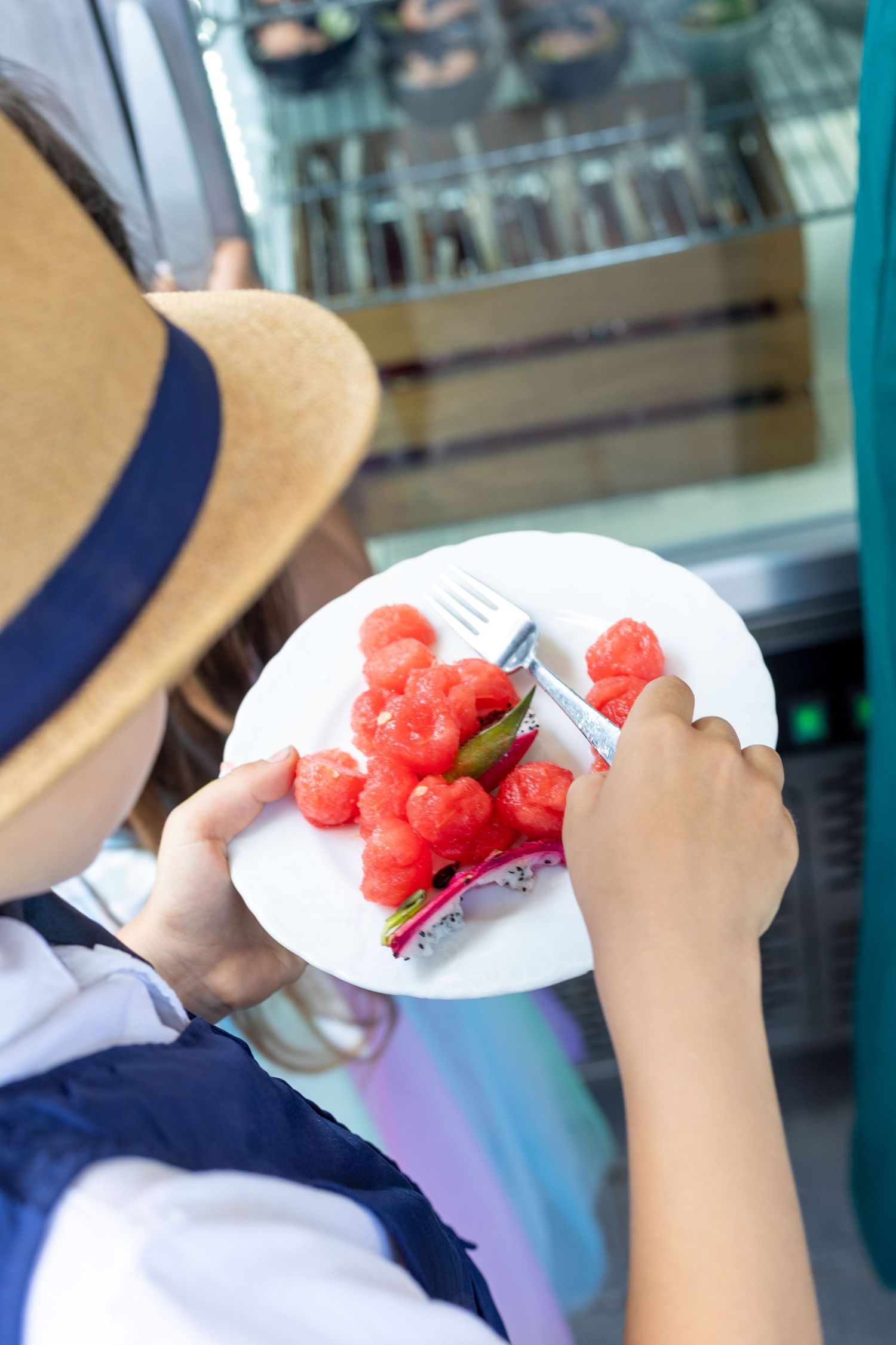 Close-up view of watermelon slices being served on white plates.