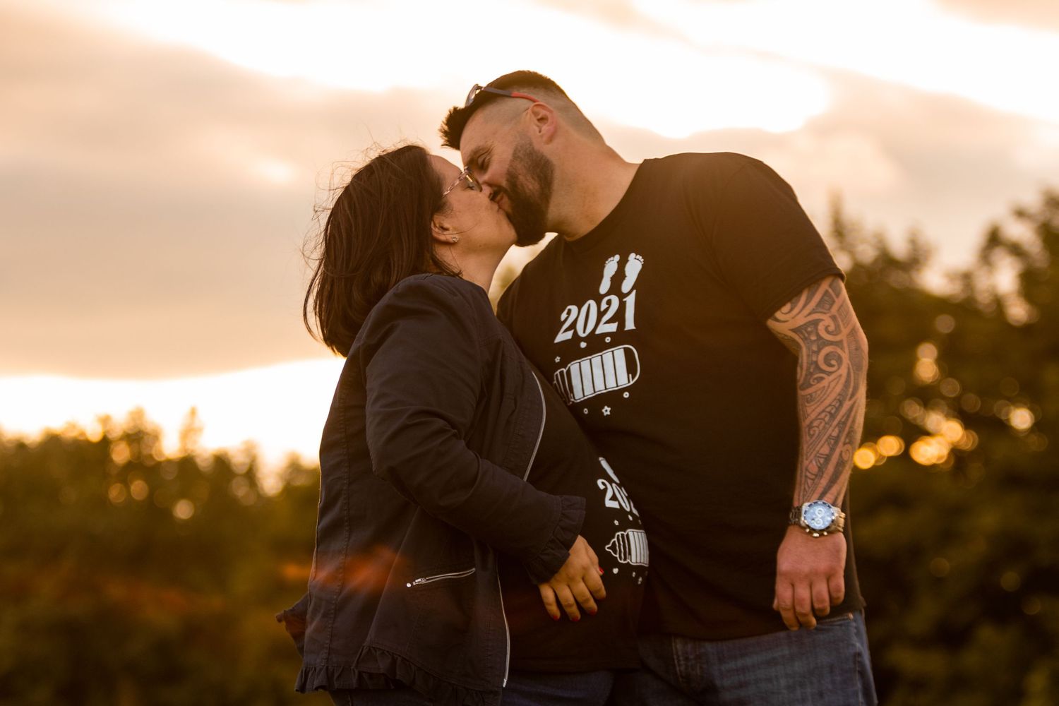 Intimate couple's portrait session at sunset with natural backlighting.