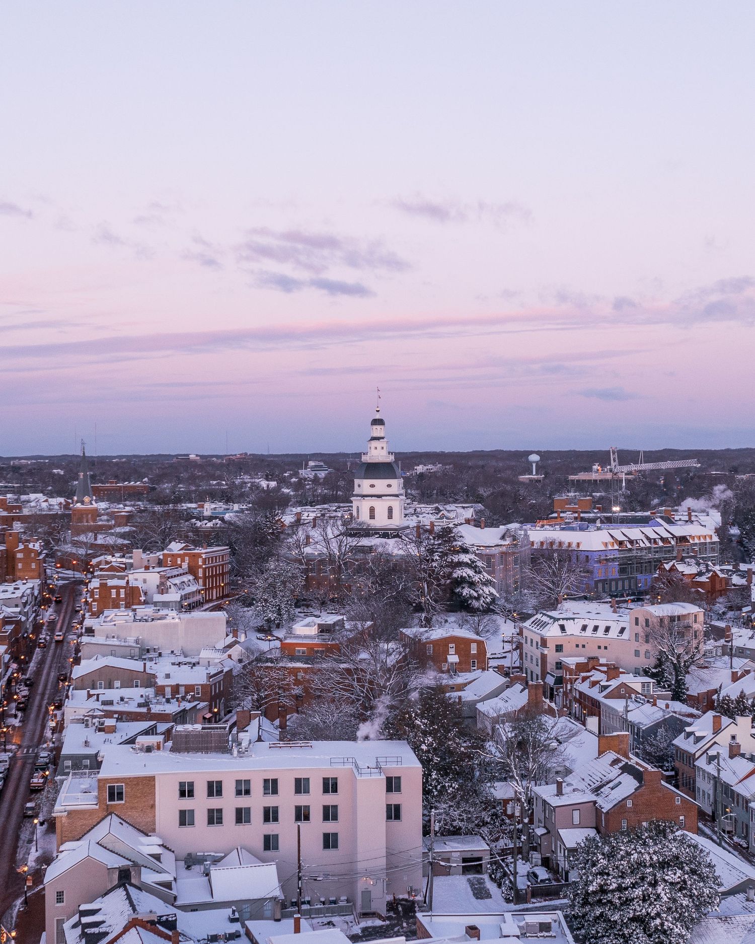 Elevated aerial view of Annapolis and waterfront under soft evening light.
