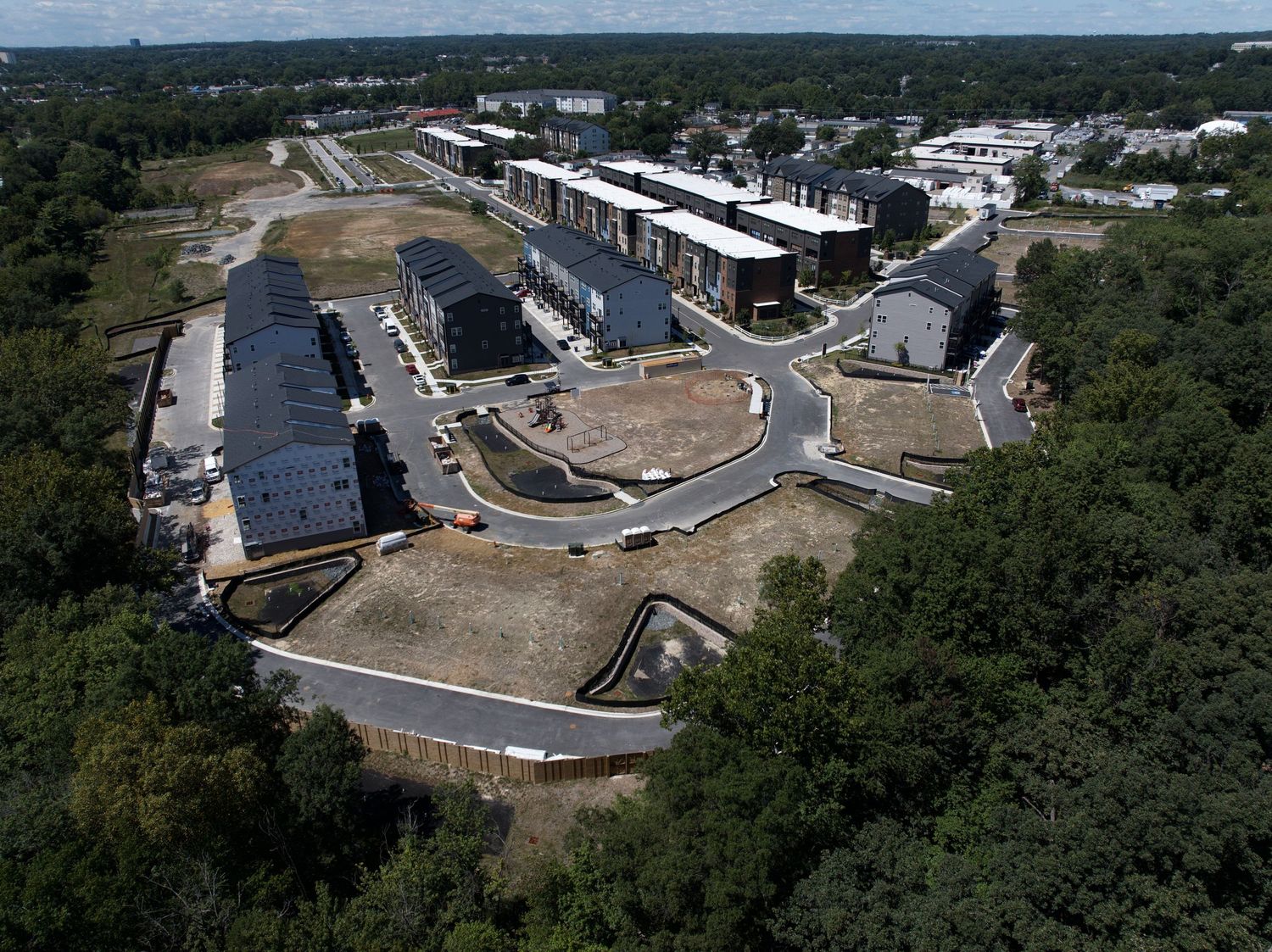 Aerial view of houses and roadways within an active development site.