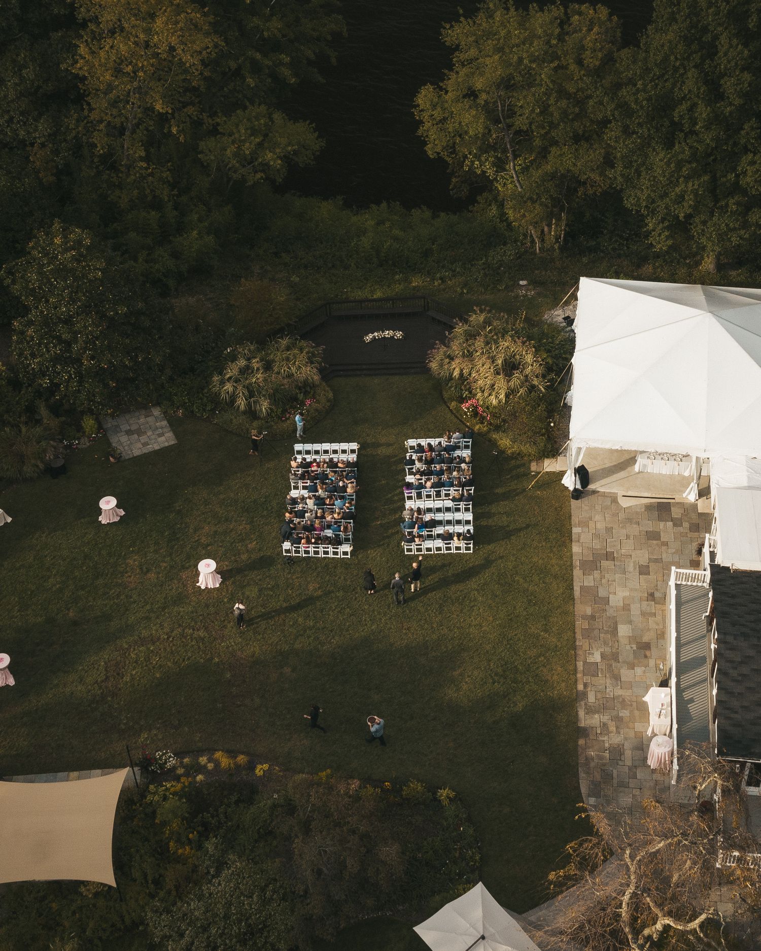 Aerial view of a wedding celebration with guests gathered at the venue.