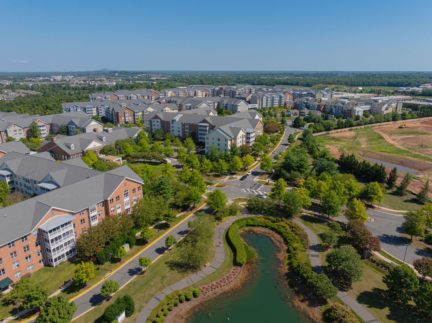 Aerial view of residential buildings and walking paths within a senior living community.