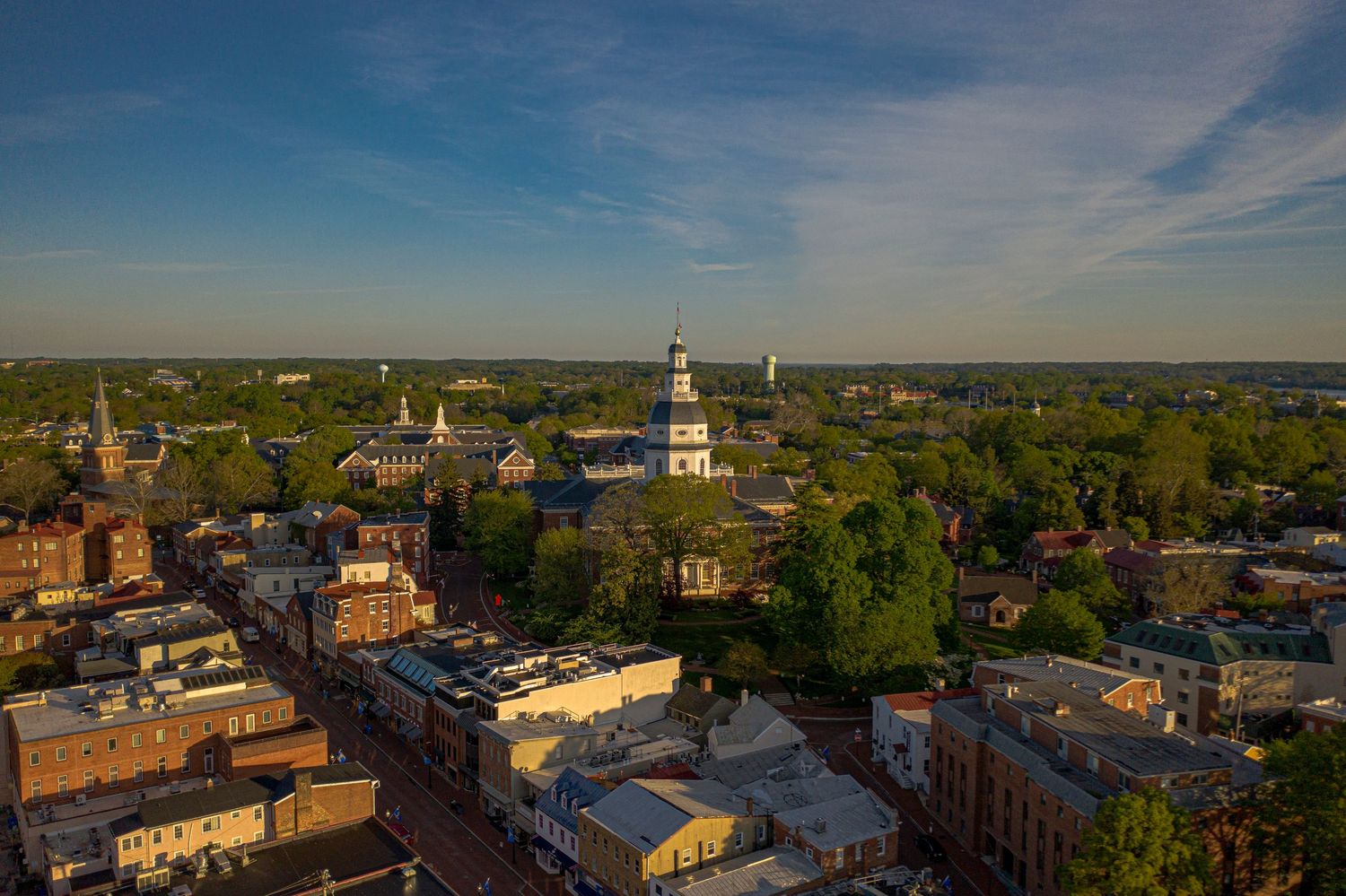 Close-up aerial view of Annapolis with the Maryland State House rising prominently over the city skyline.