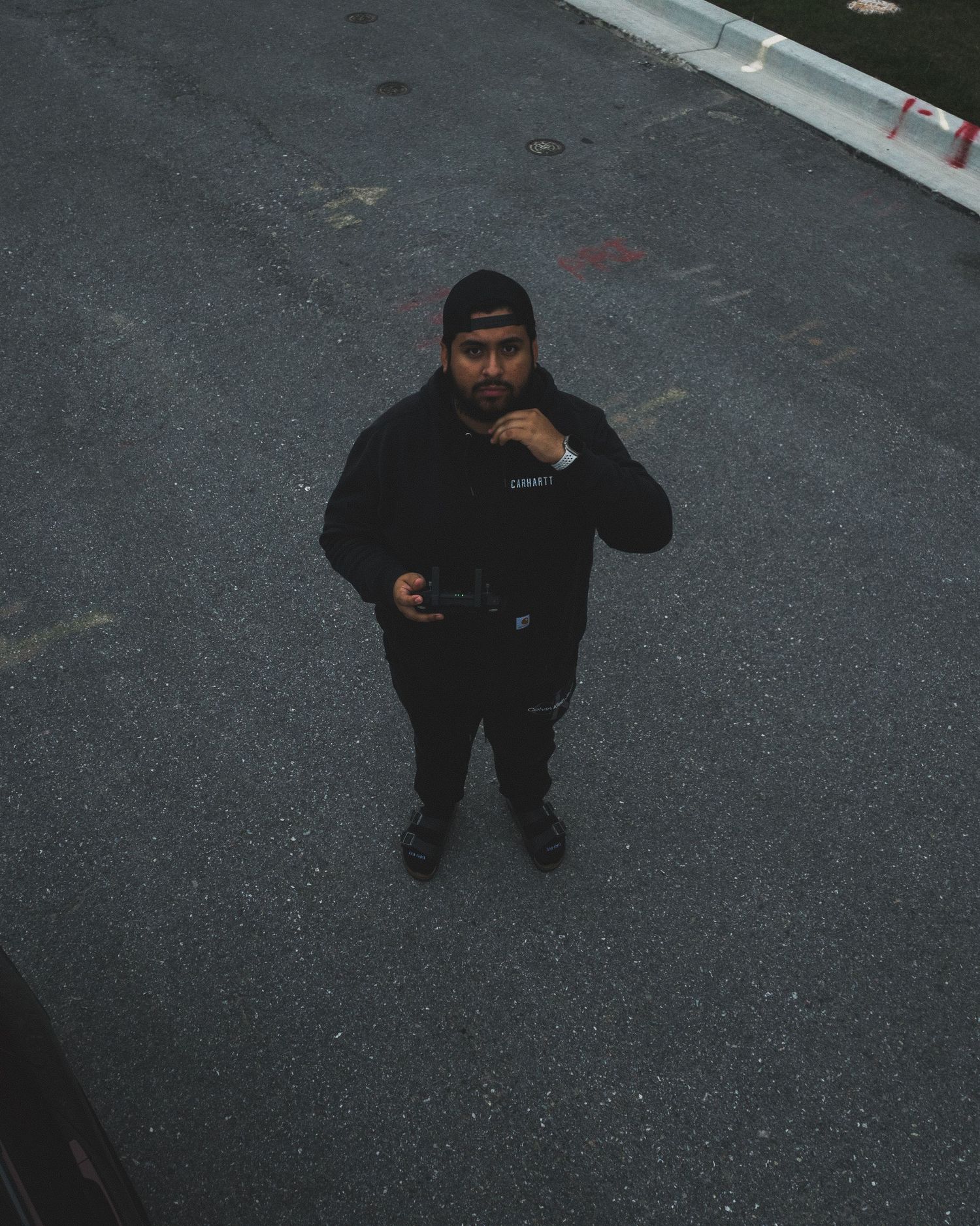 Tony Aguilar, founder of POV TXNY, holding a drone controller while preparing for aerial photography.