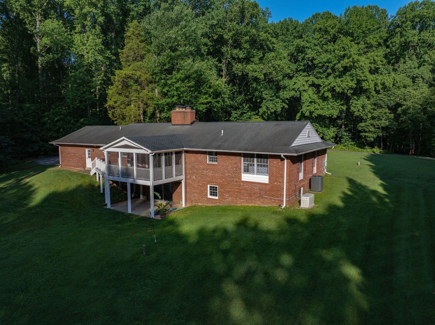 A Real Estate marketing image of a house, looking towards the house from the right side of the background showcasing the amazing property.