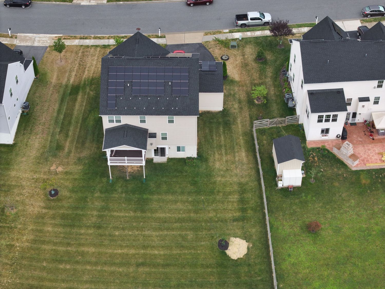 Aerial view of a backyard patio area before construction begins.