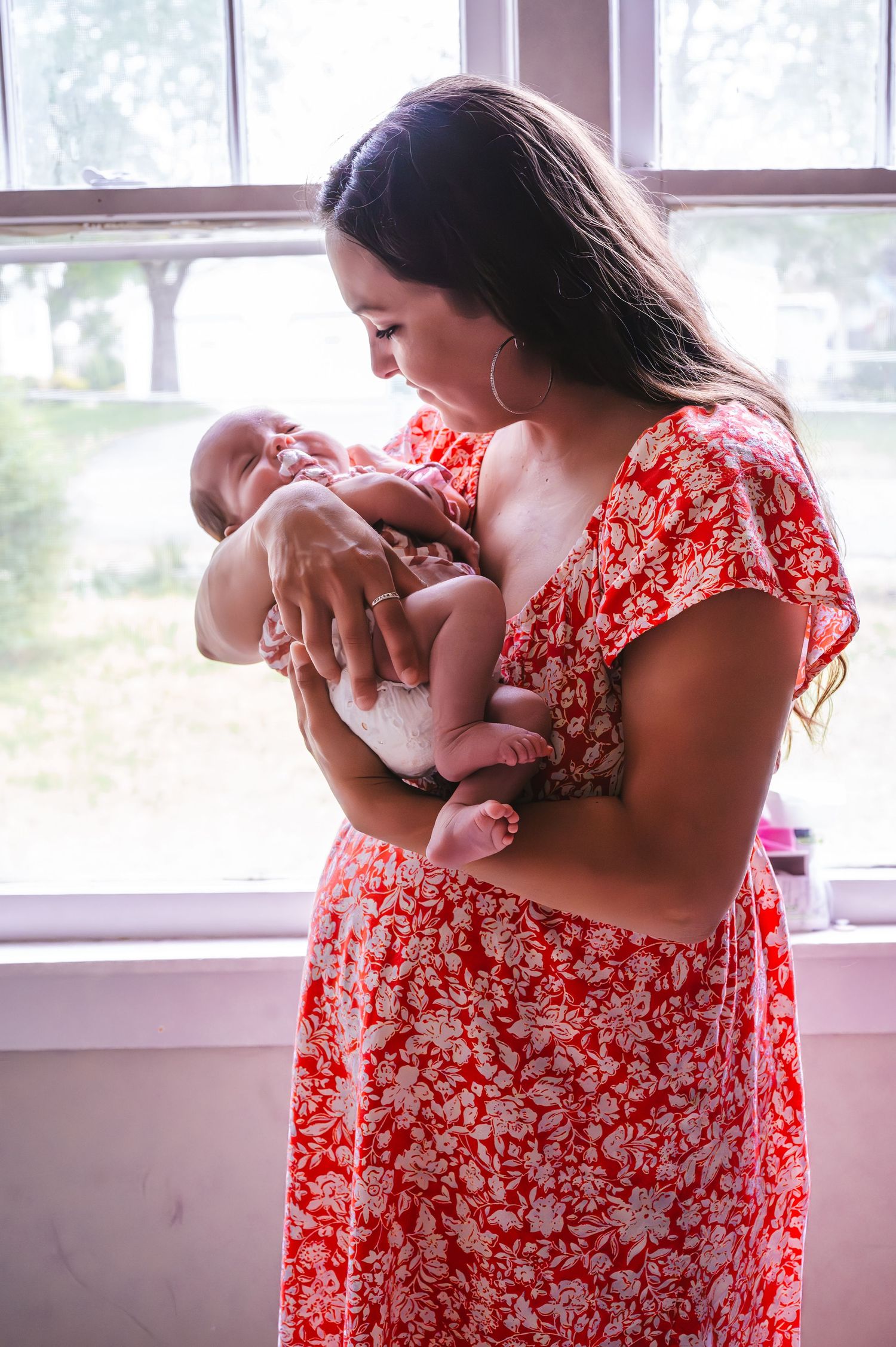 a mom holding her newborn baby
