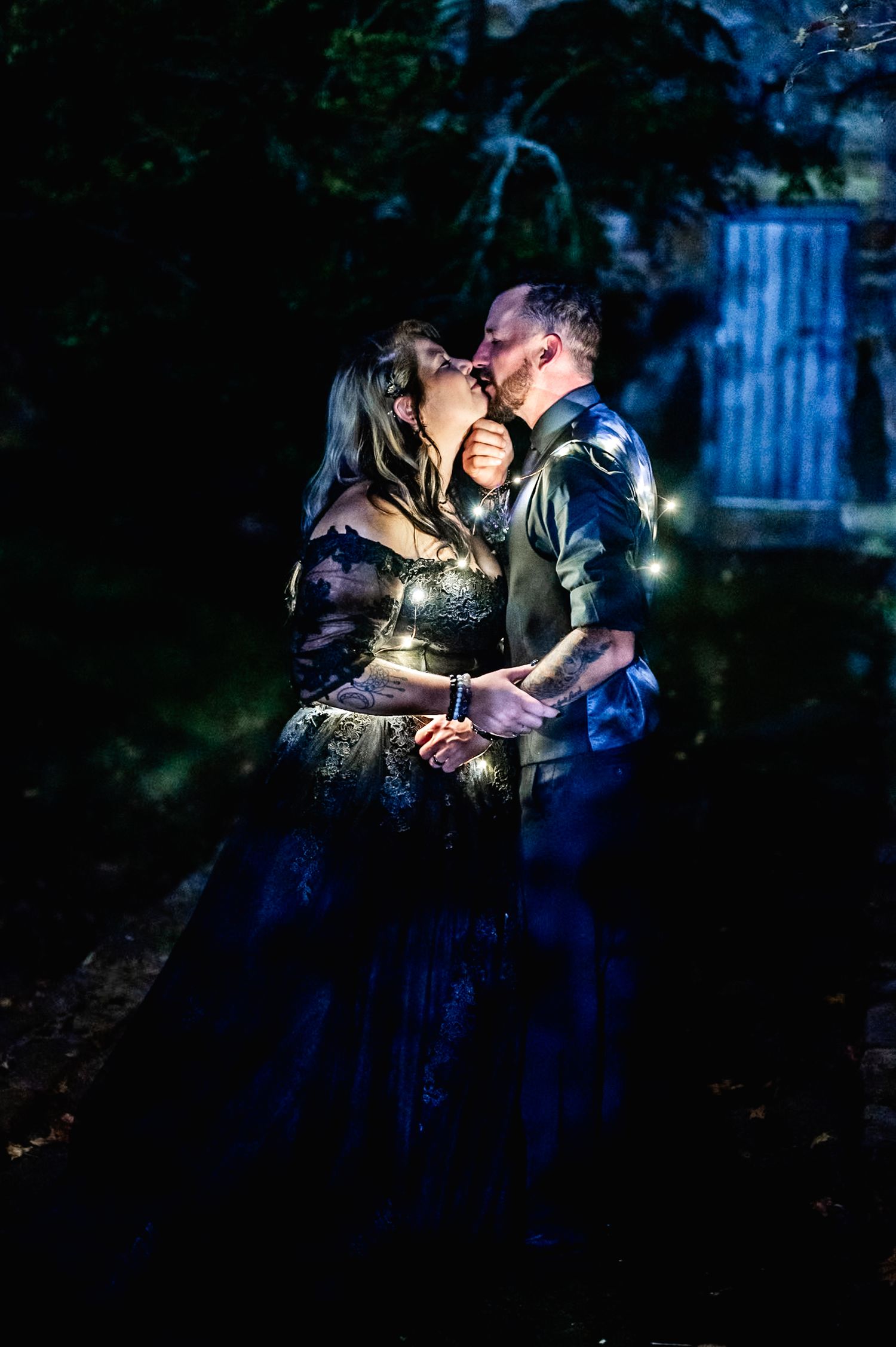 Couple sharing intimate moments in dark atmospheric lighting with blue accents.