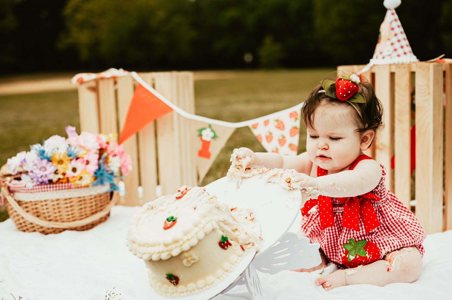 Red and white party decorations arranged on outdoor table setting.