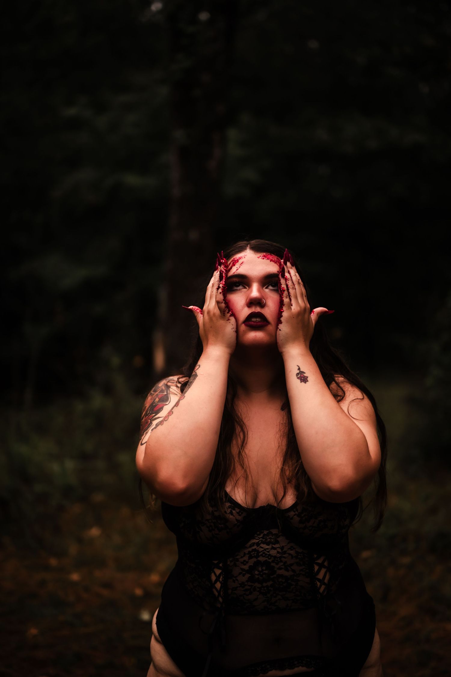 Dramatic portrait series of a person in black lace against a dark forest background.