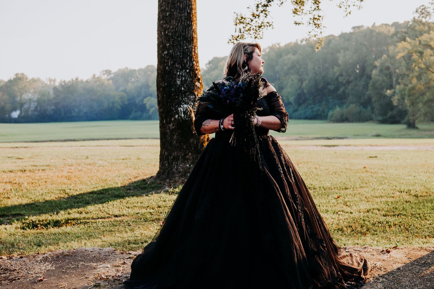 Romantic couple's portrait session in sunlit meadow at golden hour.
