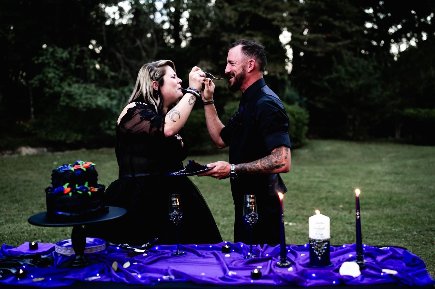 A couple shares an intimate moment during a romantic moment at their wedding at dusk.