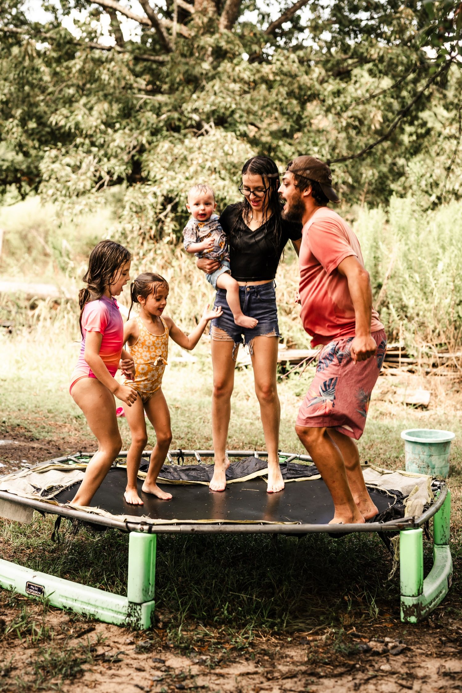 Sequence of playful jumping photos on an outdoor trampoline in a backyard setting.