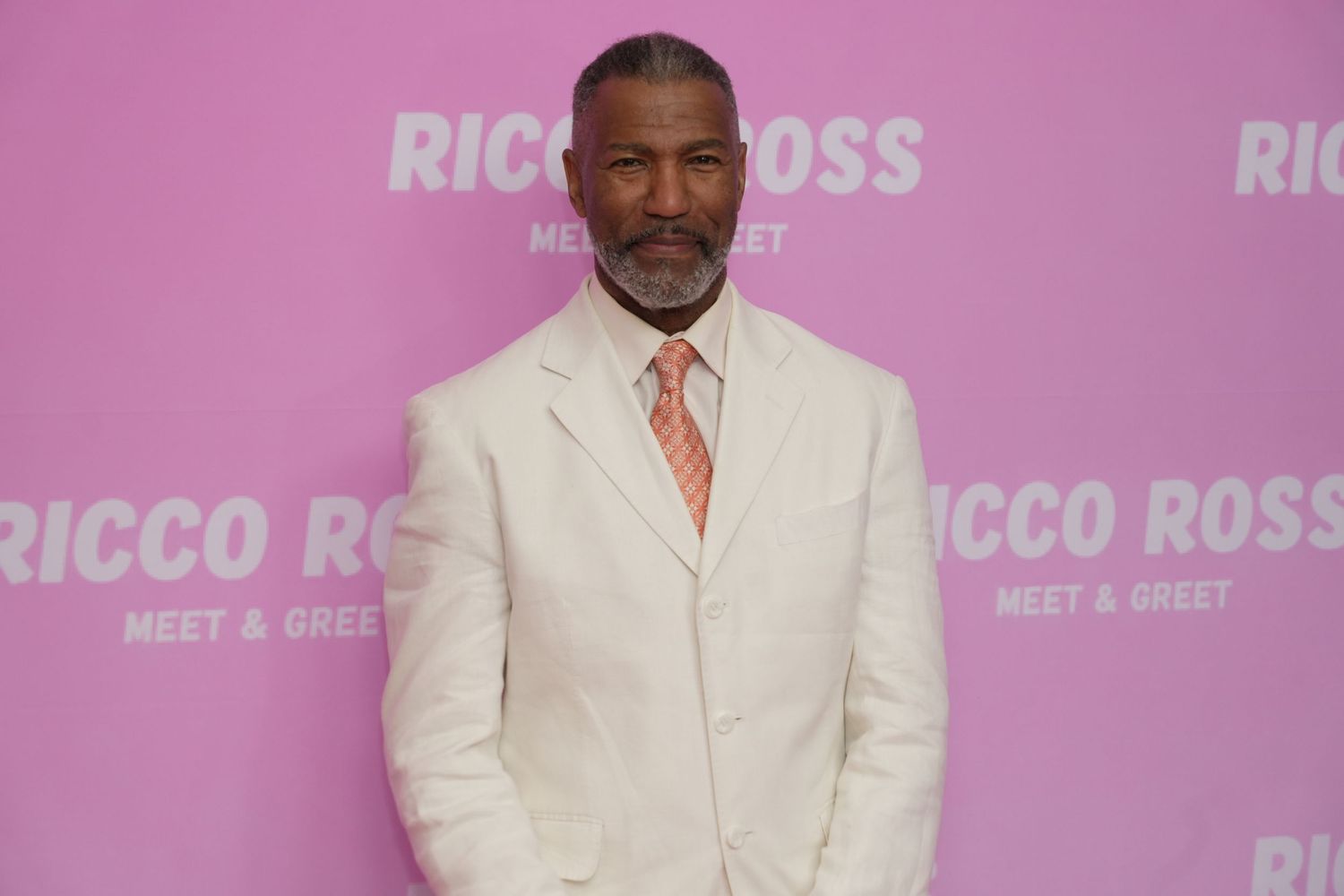 Ricco Ross posing on the pink carpet produced by Shootworks