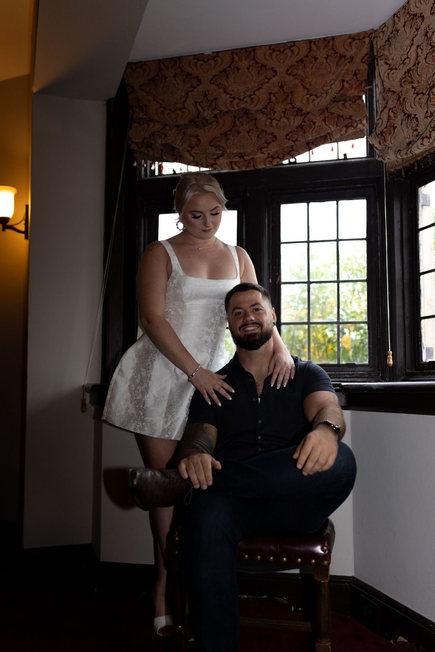 Intimate and cozy engagement session moment with a warm, moody aesthetic inside Stokesay Castle.