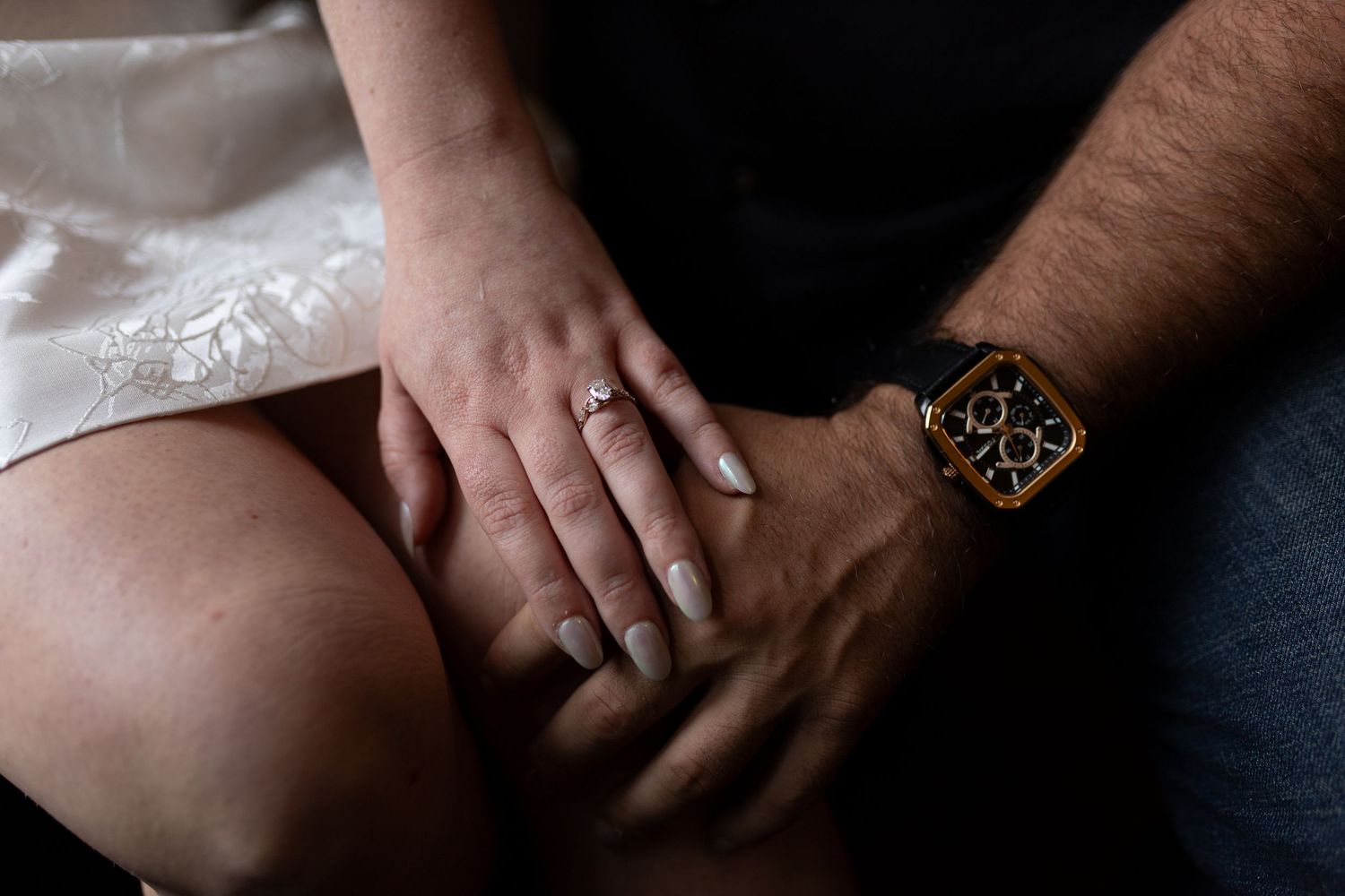 Close-up of an engagement ring with the dark, 'old money' textures of Stokesay Castle in the background.