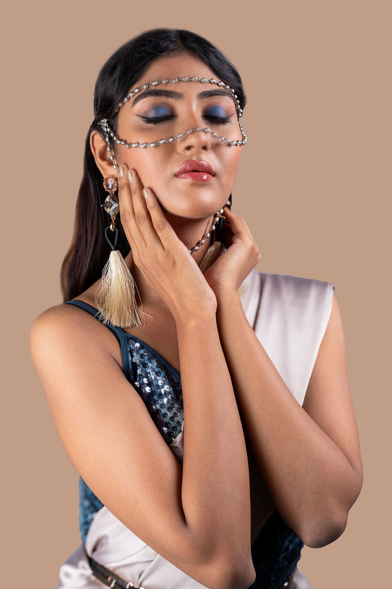 Fashion portrait series with ornate accessories and expressive hand poses against beige background.