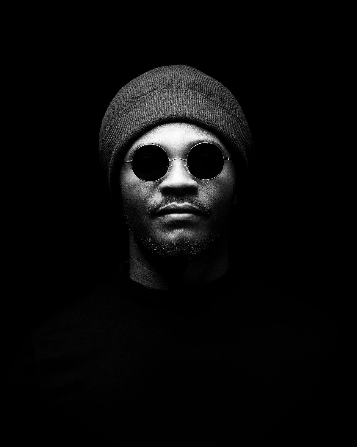 High contrast black and white portraits showing only eyes and face fragments in darkness.