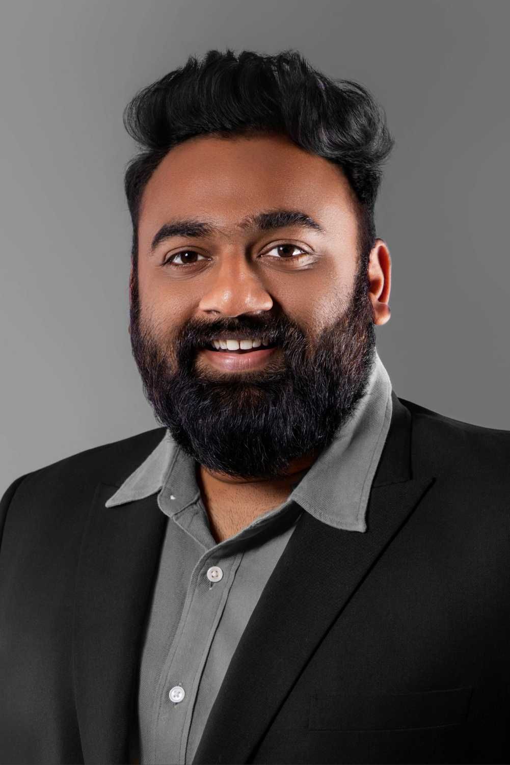 Professional headshot series showing different expressions and angles against a gray background.