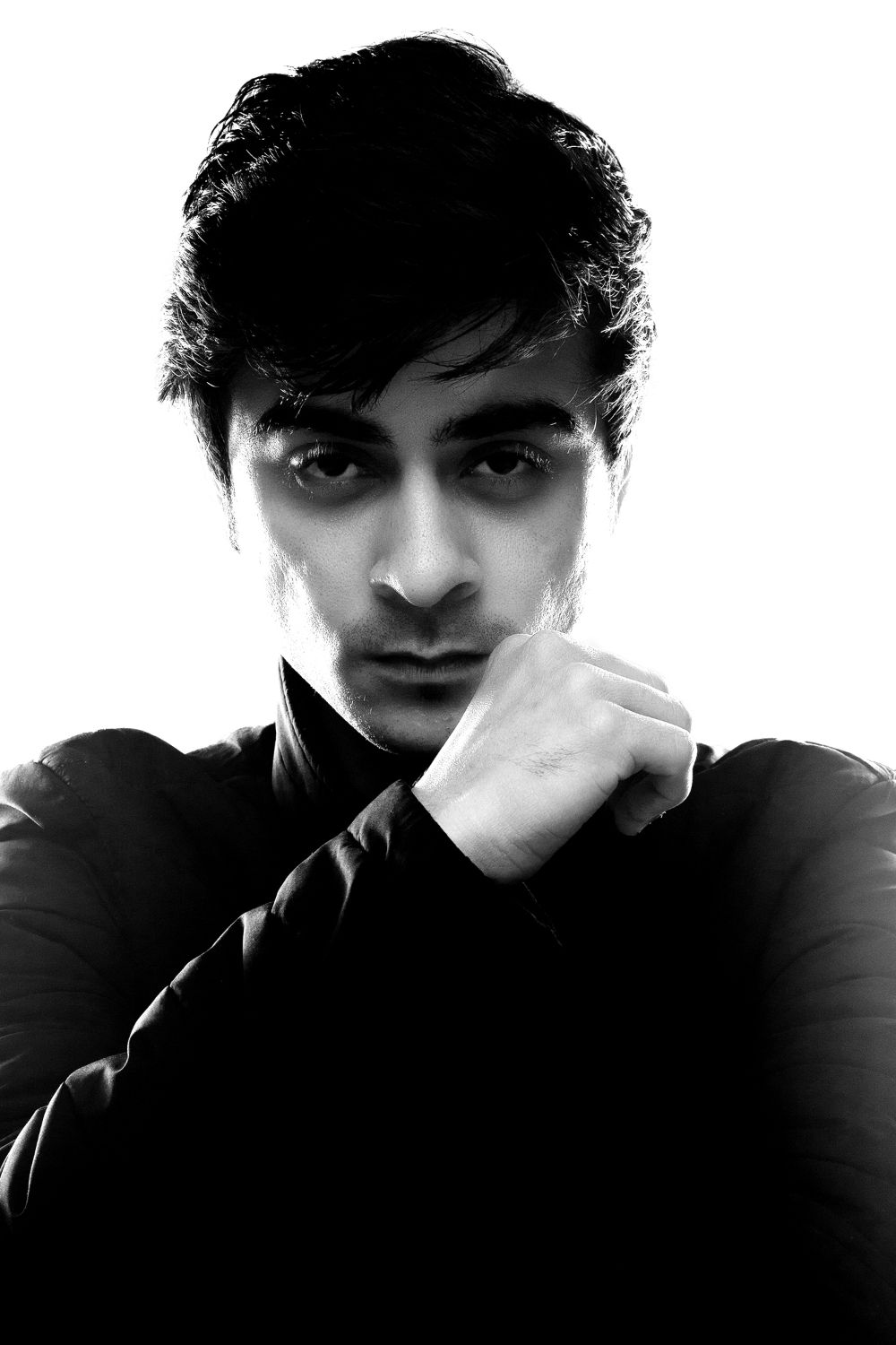 Moody black and white portrait series with dramatic shadows and contemplative expressions.