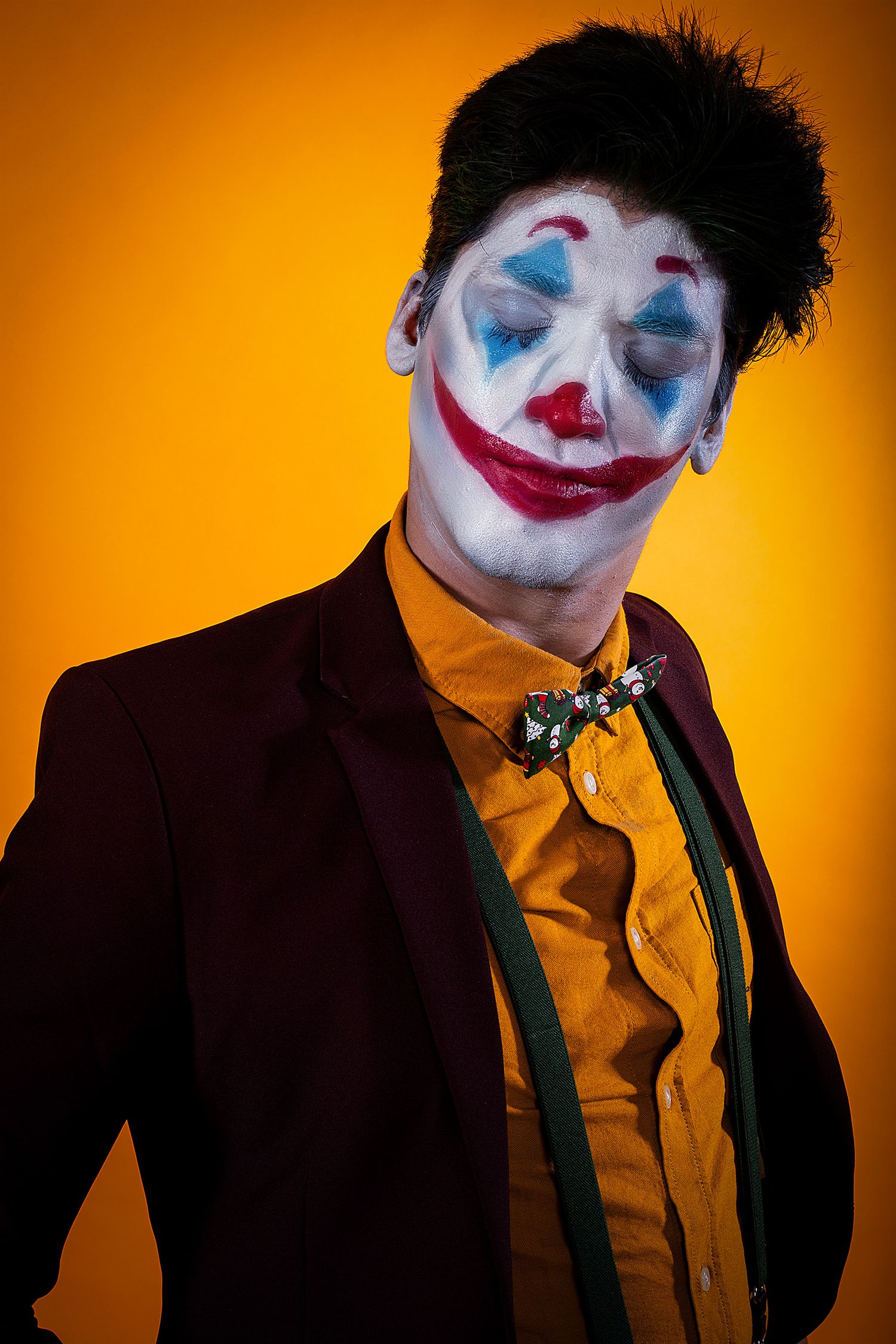 Dramatic clown makeup portrait series against orange background with theatrical lighting.