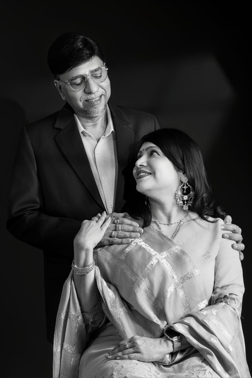 A romantic black and white photo series showing a couple in formal attire sharing intimate moments together.