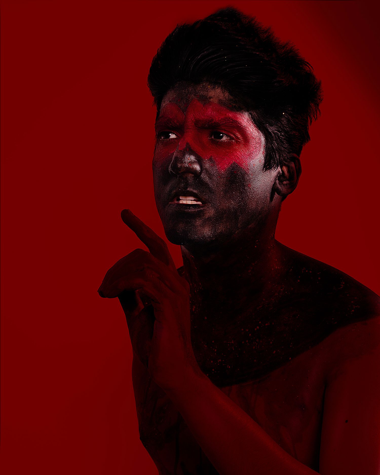 Dramatic portraits with red lighting showing expressive emotions against dark background.